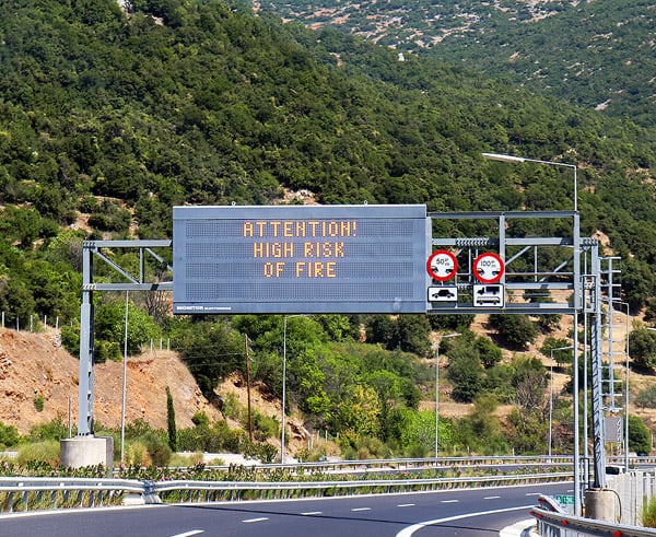 A photo of a highway sign we passed in Greece. It is warning drivers of the dangerous forest fires. 