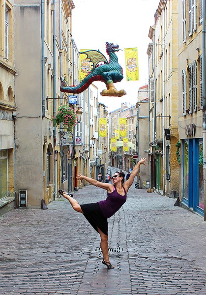 Robyn holding a dance pose on an empty street in the gorgeous town of Metz, France. It is important to celebrate any win!
