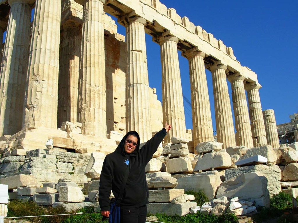 Standing and pointing to the Acropolis in Athens, Greece, on my first backpacking trip.