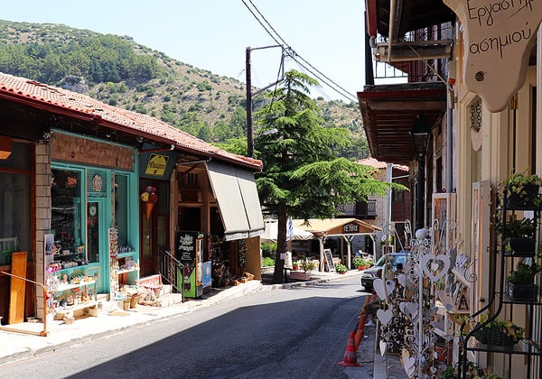A narrow road lined with shops in the town of Dimitsana, Greece.