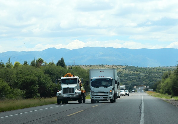 A large truck passing another on a single lane highway. This was a common sight on our Mexican road trip.