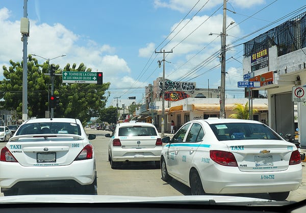 This is a 2 lane road in Playa del Carmen, but these taxis have made it a 3 lane road. The rules of driving in Mexico are different, and not always clear.
