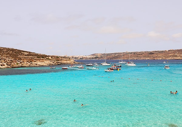 The bright, turquoise water surrounding Comino Island. The water is warm and perfect for swimming.