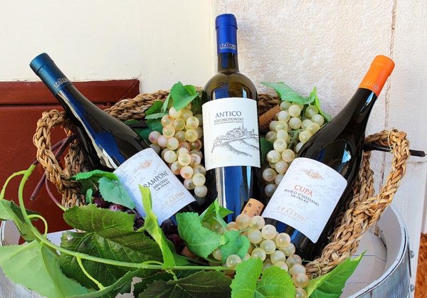 Three bottles of wine in a wicker basket. Locorotondo produces some of the best wines in Italy.