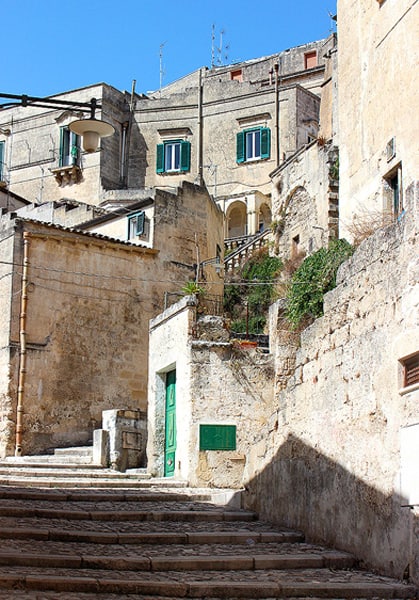 A shaded staircase leading to a quiet street.