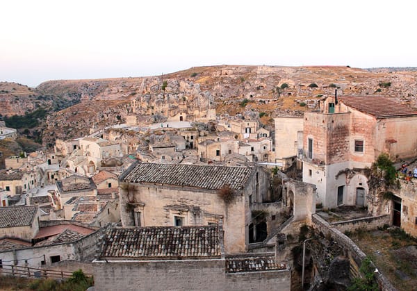 The town of Matera is shades of pink as the sun starts to set.