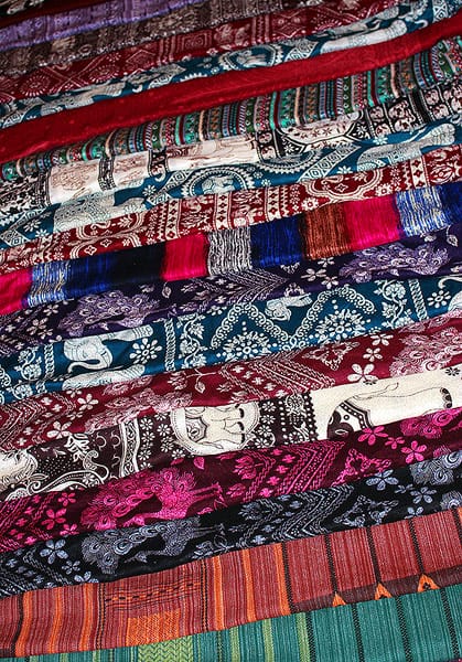 Beautiful, delicate textiles from a market in Thailand. Each scarf or textile has a different design and uses bright pinks, blues and turquoise colors.