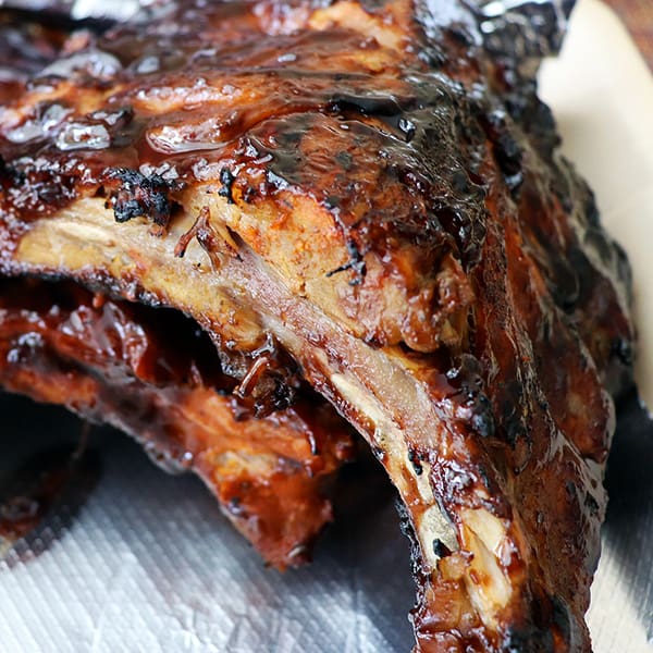 Delicious stack of ribs from Bruno's Roadside BBQ Rib stand in Ajijic, Mexico. Eating local food helps to reduce cost and allow you to spend less money while traveling.