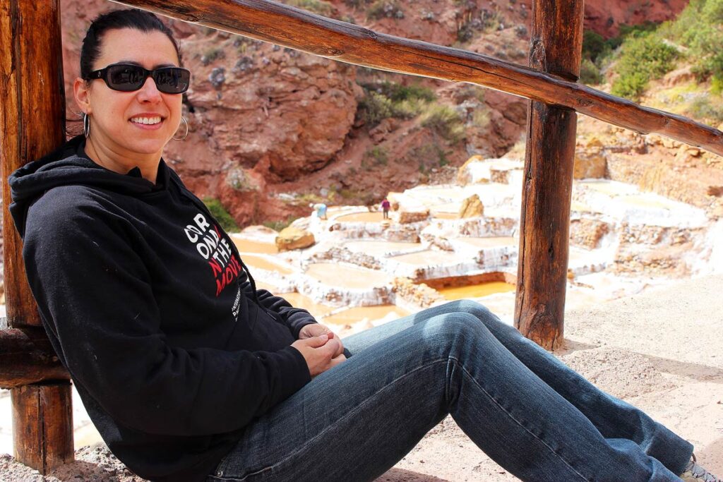 Robyn sitting by the Salinas de Maras near Urubumba, Peru.