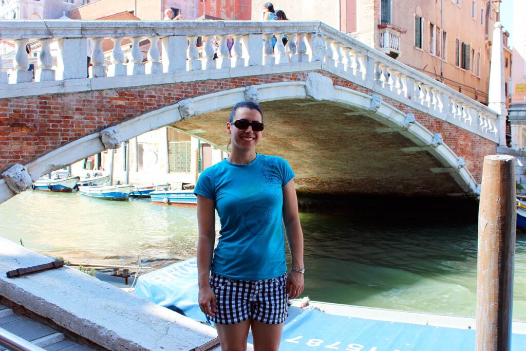 Robyn standing in front of a bridge in Venice. Visiting Italy was a bucket list moment!