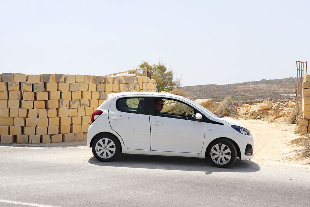 Driving in Malta is an amazing experience. This is Gavin sitting in our tiny white rental car.