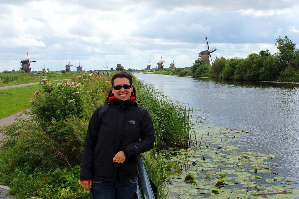 Robyn standing in front of the windmills of Kinderdijk, a must see when spending 2 weeks in the Netherlands.