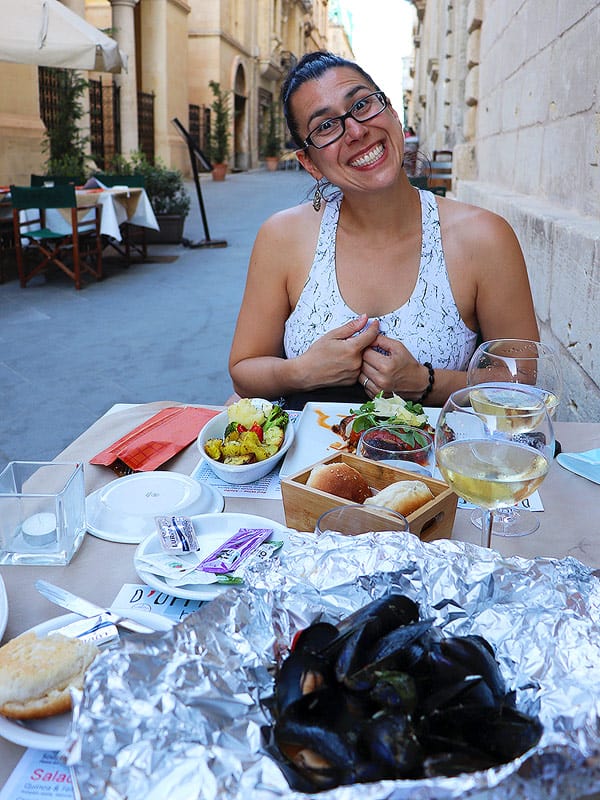 Robyn enjoying a full meal on a street patio in Valletta. Valletta is the place to eat if you want the best restaurants in Malta.