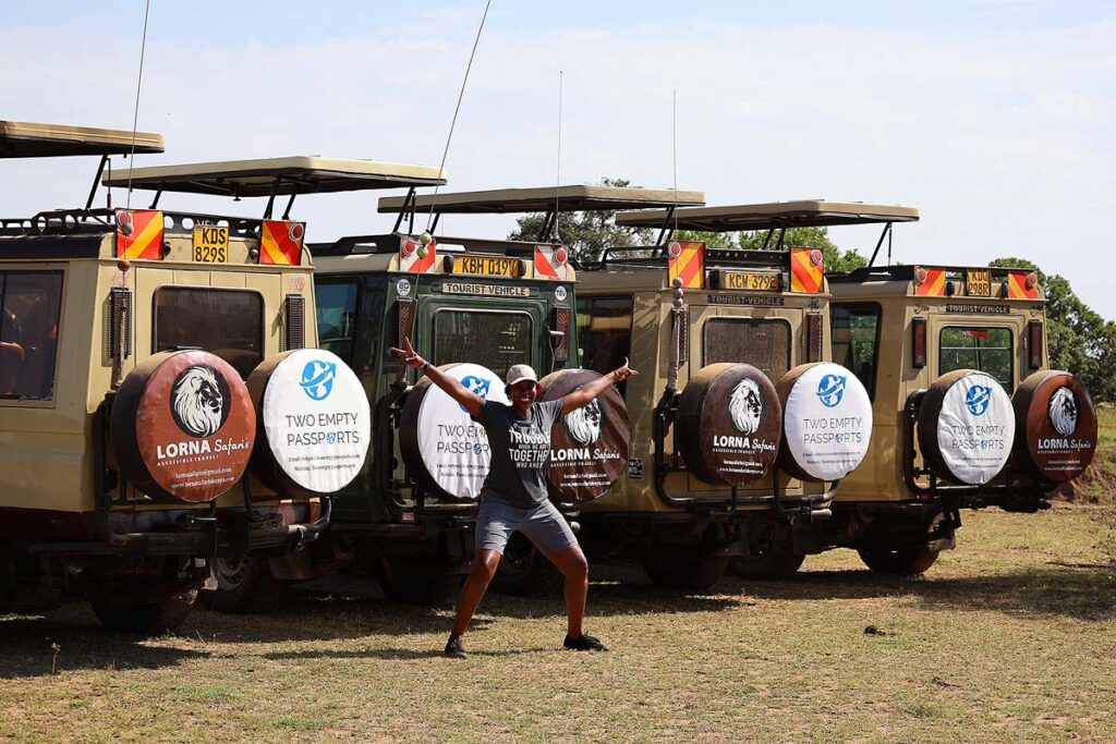Judy, the founder of Lorna Safaris, posing in front of the 4 accessible jeeps during our accessible Kenya safari.