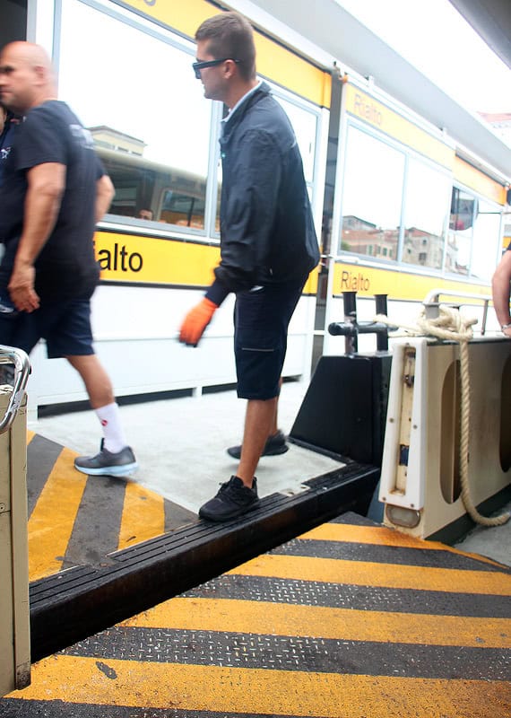 A Vaporetto worker getting ready to help lift my wheelchair onto the Rialto platform because the tide is low and the platform does not line up with the boat.