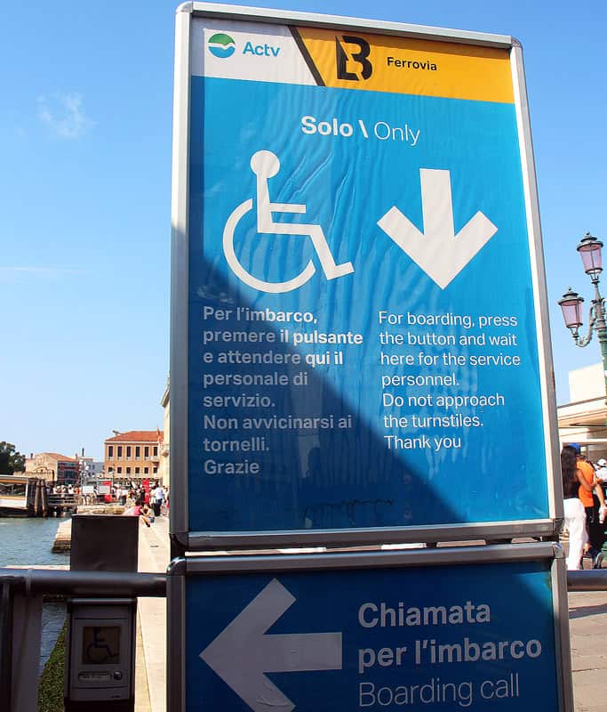 A blue wheelchair sign at a Vaporetto station showing where to wait on the platform for assistance. Taking a vaporetto in Venice is the best way to get around with limited mobility.